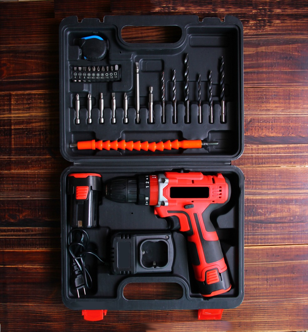electric drill set in a box on a wooden floor