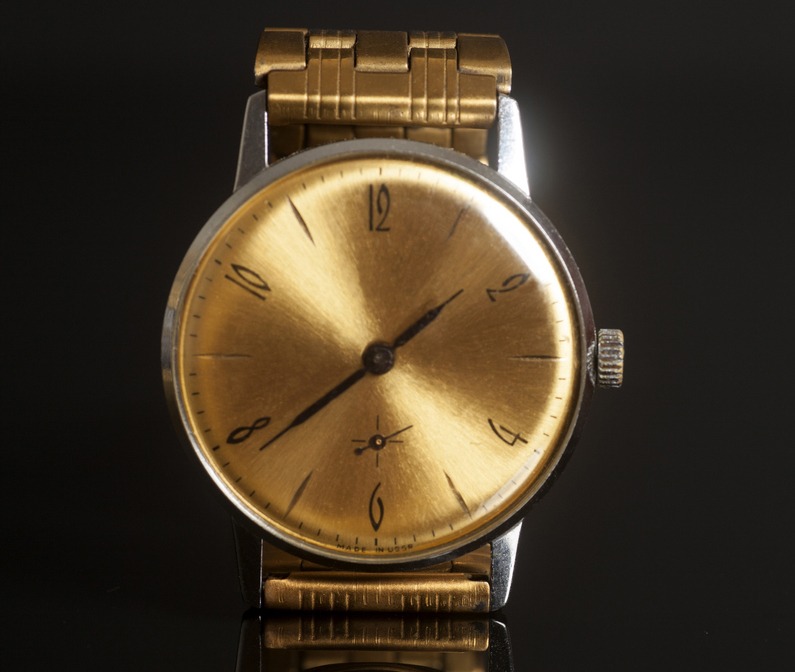 vintage gold wrist watch on black background