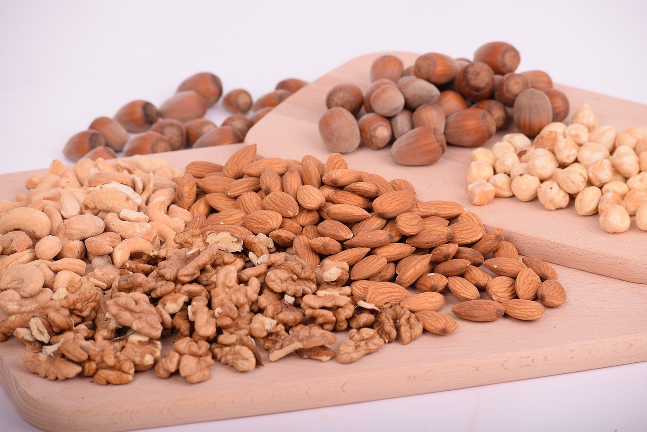 Different kinds of nuts on wooden trays