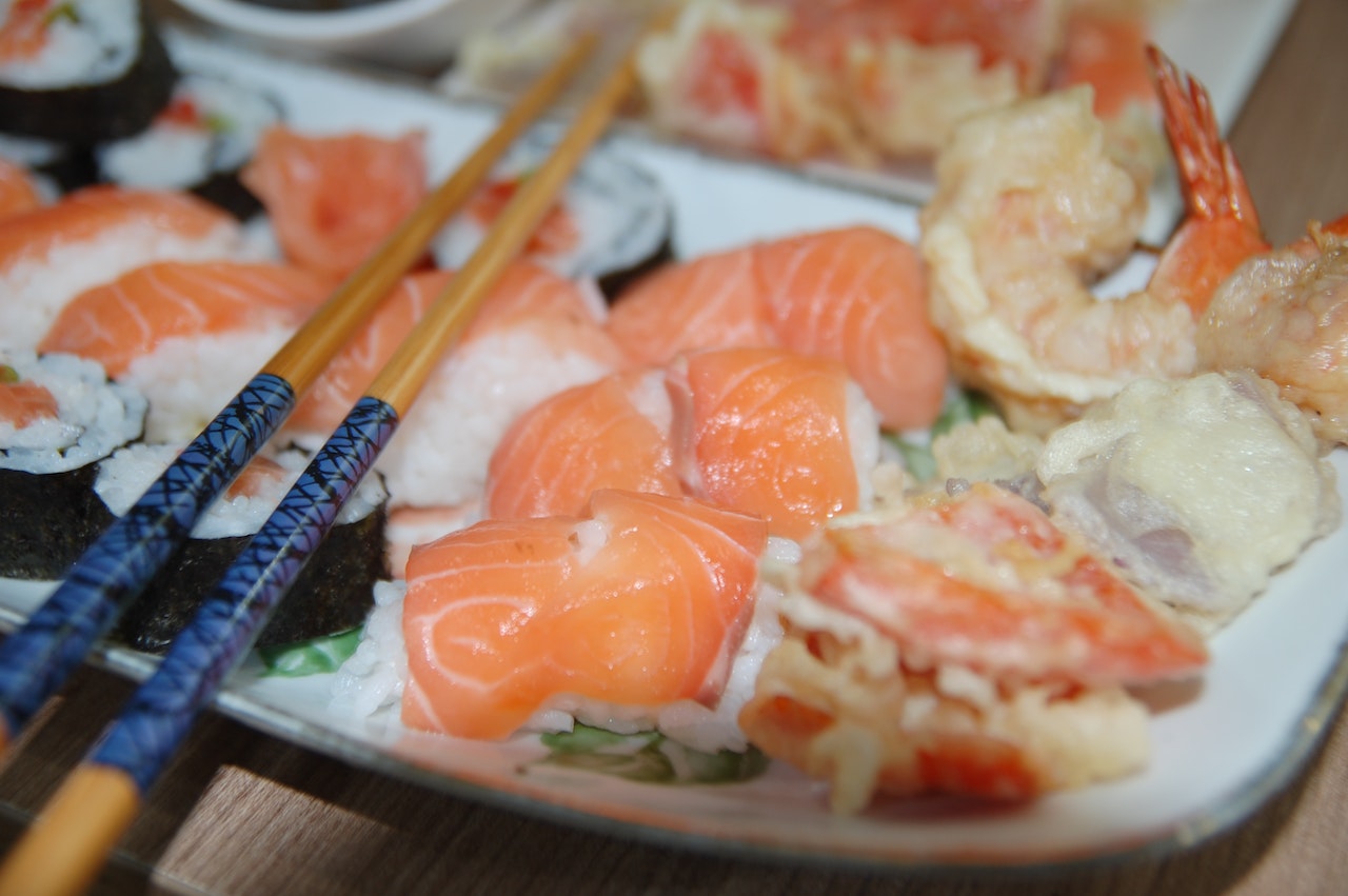 Raw salmon sashimi served on a plate with wasabi