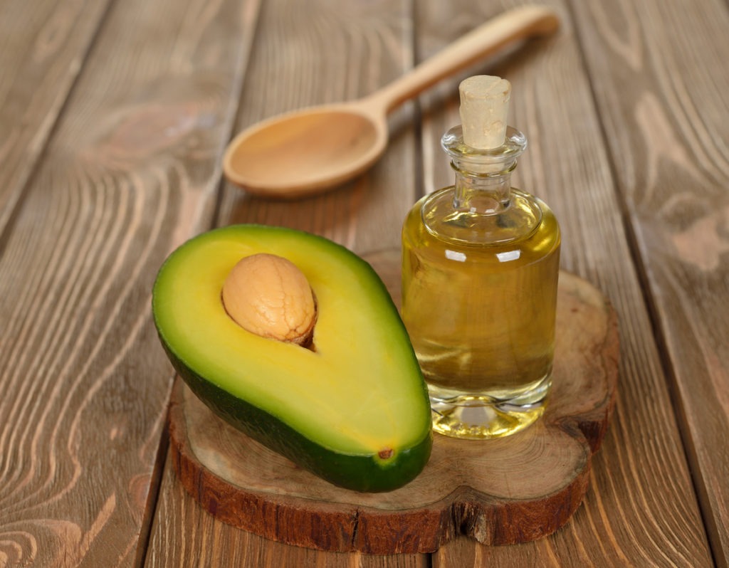 Avocado oil on a brown table. Source: 