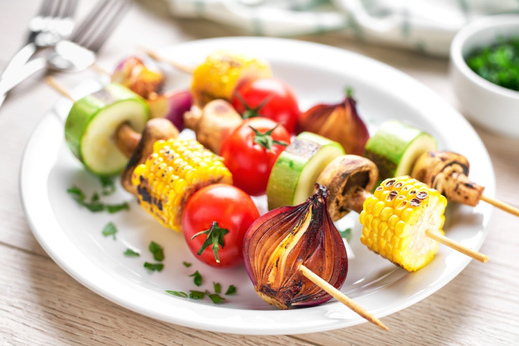 vegetable kebabs on skewers grilled on grill or BBQ  on a white plateon a white plate,selective focus. grilled vegetables.