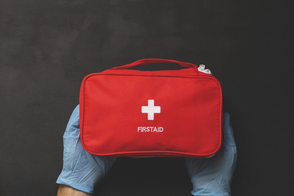 first aid kit on the wooden background