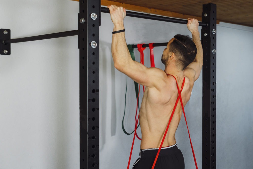A man using resistance bands for pull-ups