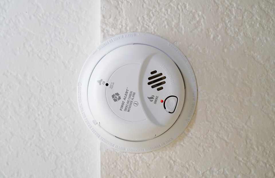 A smoke detector mounted in a wall.