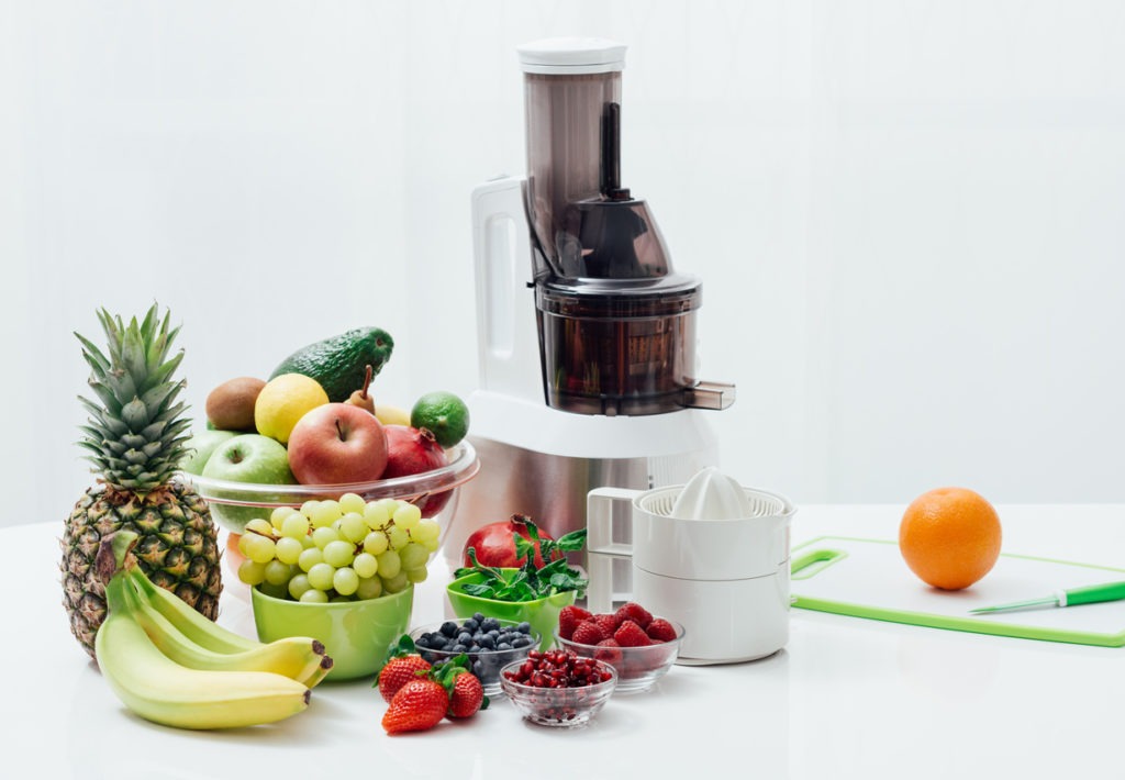 Fresh organic fruit and juicers on a table, healthy eating, and nutrition concept