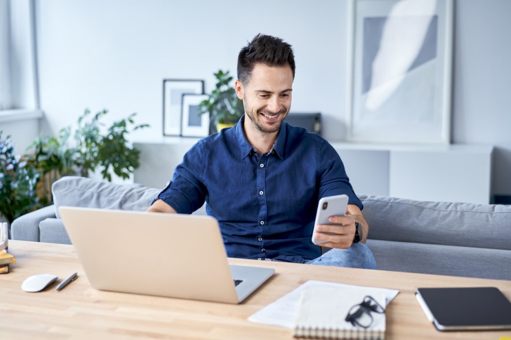 Man looking at phone while working