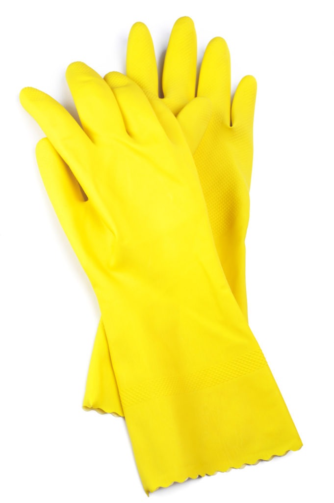 a pair of yellow rubber gloves in white background