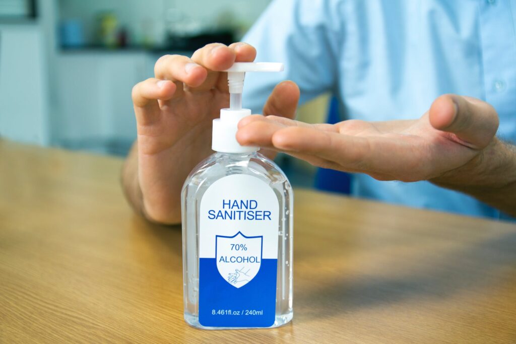 a picture of a person pumping sanitizer)