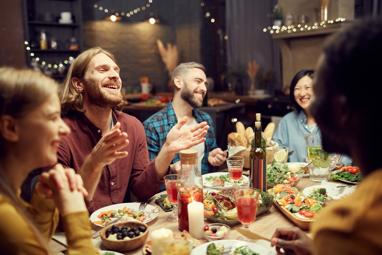 people-laughing-at-dinner-table