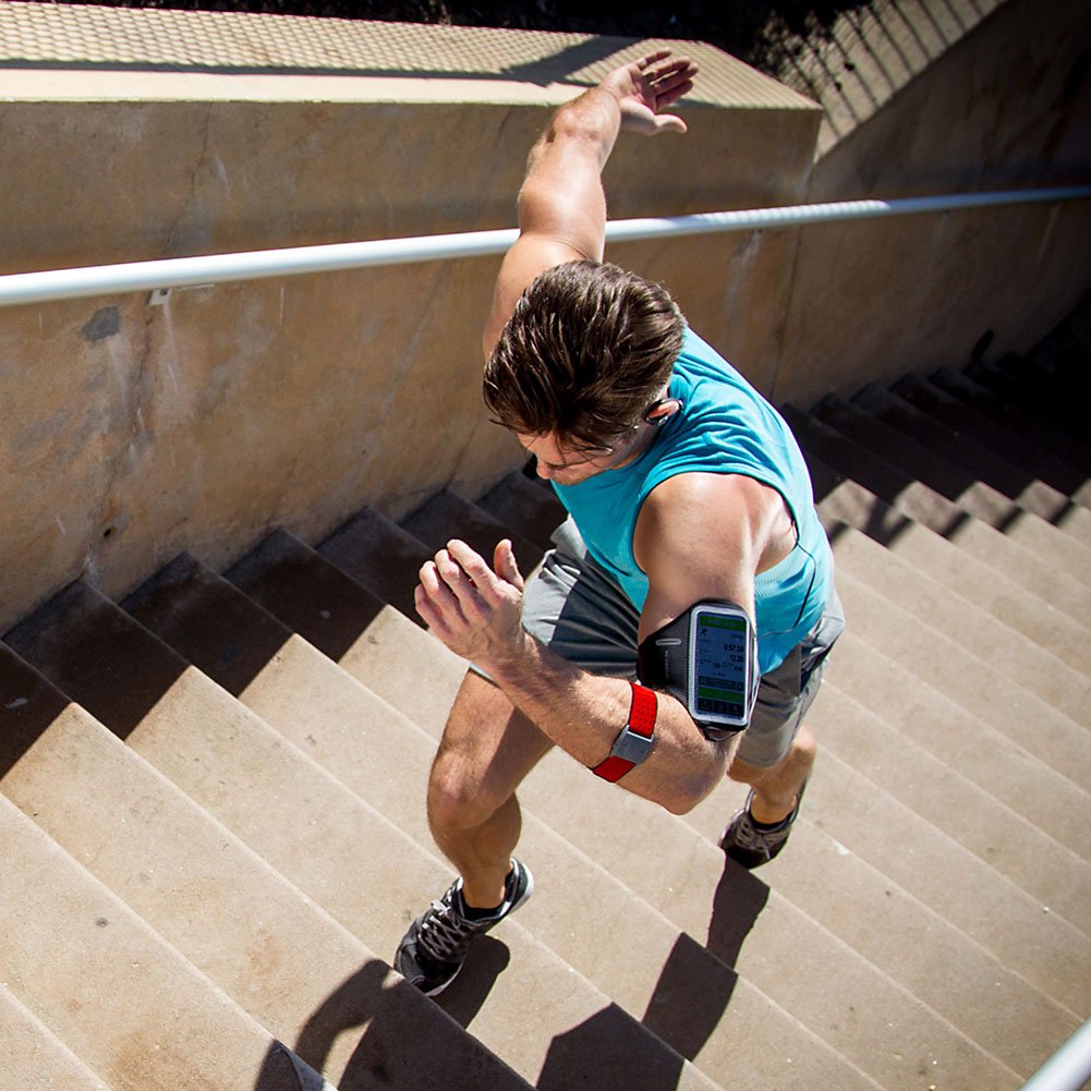A man wearing a heart rate monitor and running on the stairs