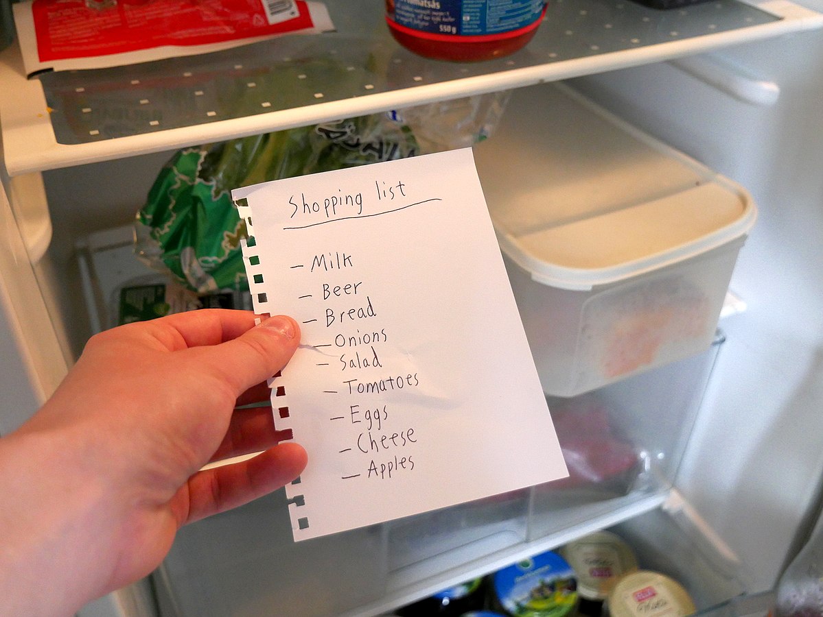 a post it with a grocery list written on it