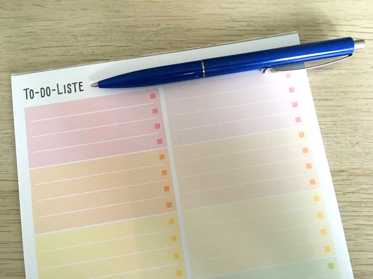 a to-do list on a notepad with a pen