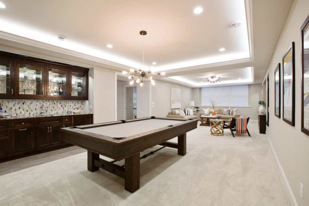 Beautiful basement entertaining room with LED lighting in tray ceiling