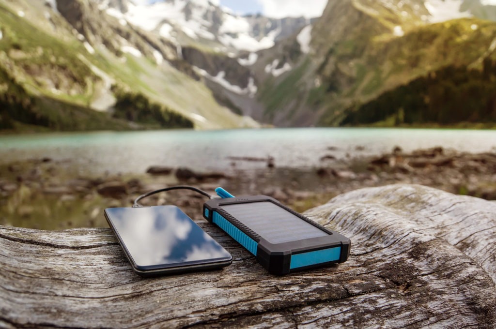 A battery solar energy device on the background of beautiful mountain scenery