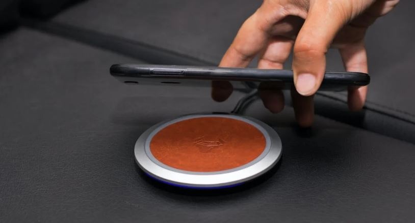 A person putting smartphone on wireless charger.
