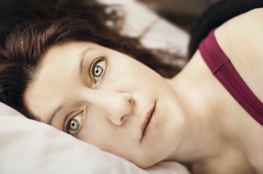 Woman laying wide awake in bed