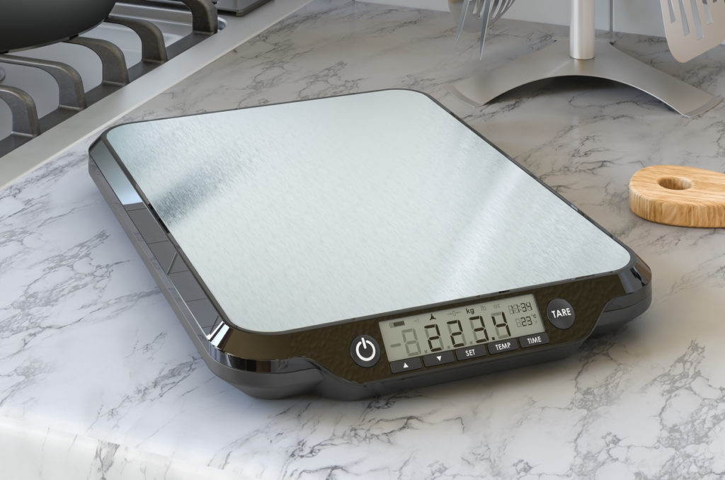 Digital kitchen scales on the kitchen table. 3D rendering