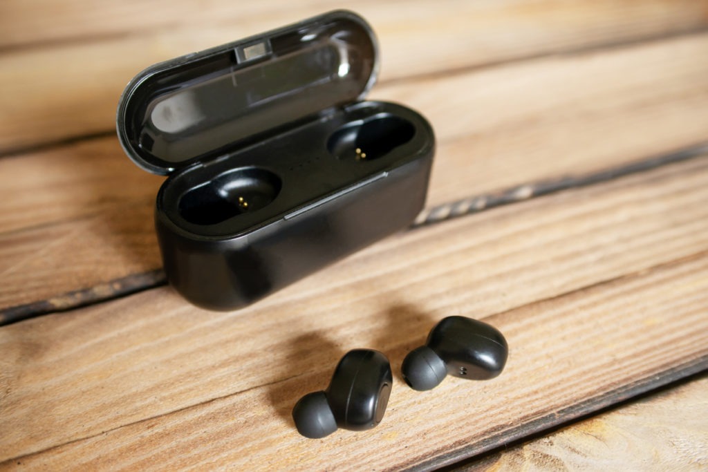 Wireless headphones are on a wooden desktop