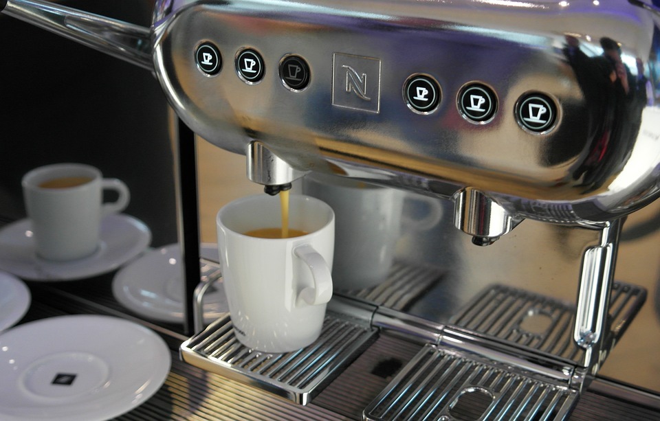 coffee pouring into a white mug from a coffee machine