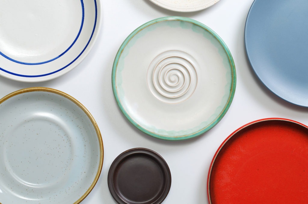 Various empty plates on white table, top view