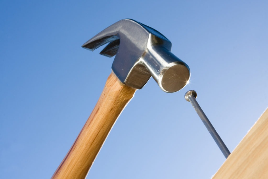 A hammer hitting a nail