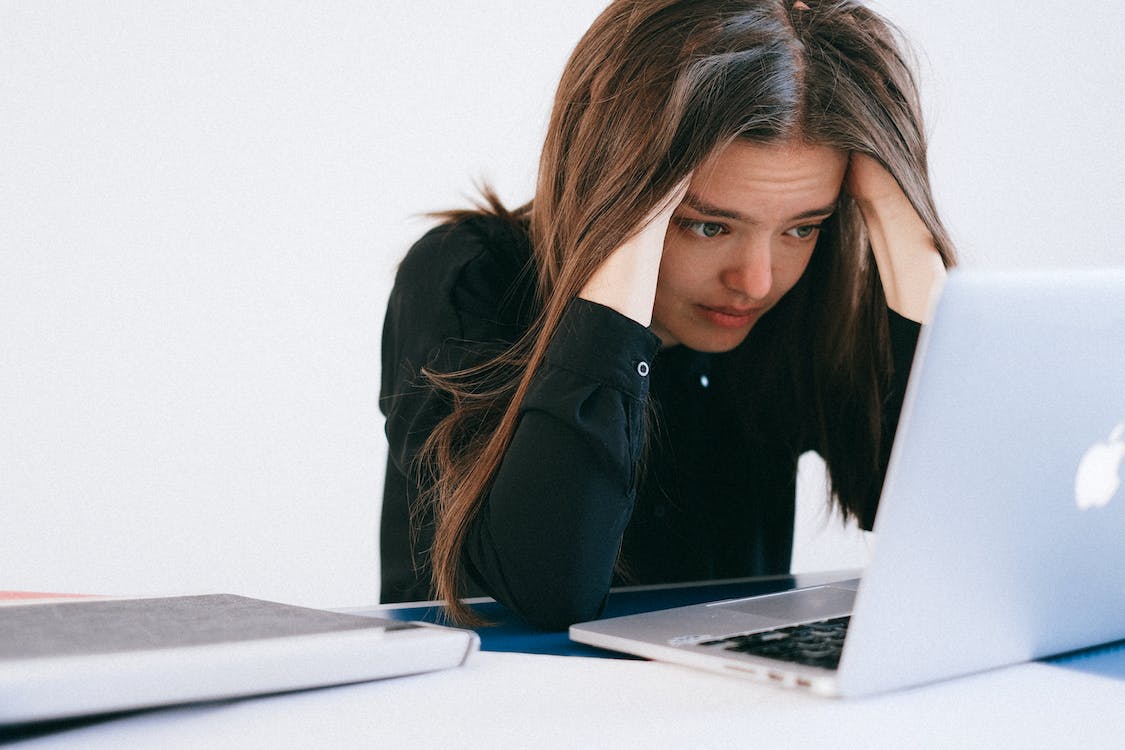 a woman using laptop and stressed