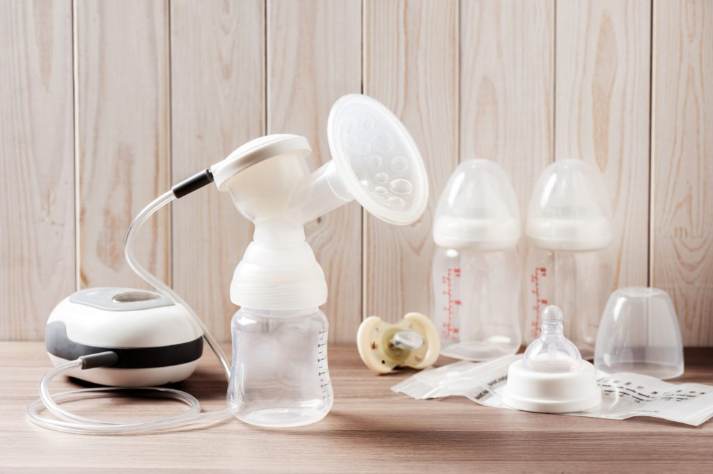 an-electric-breast-pump-and-empty-feeding-bottles-scaled