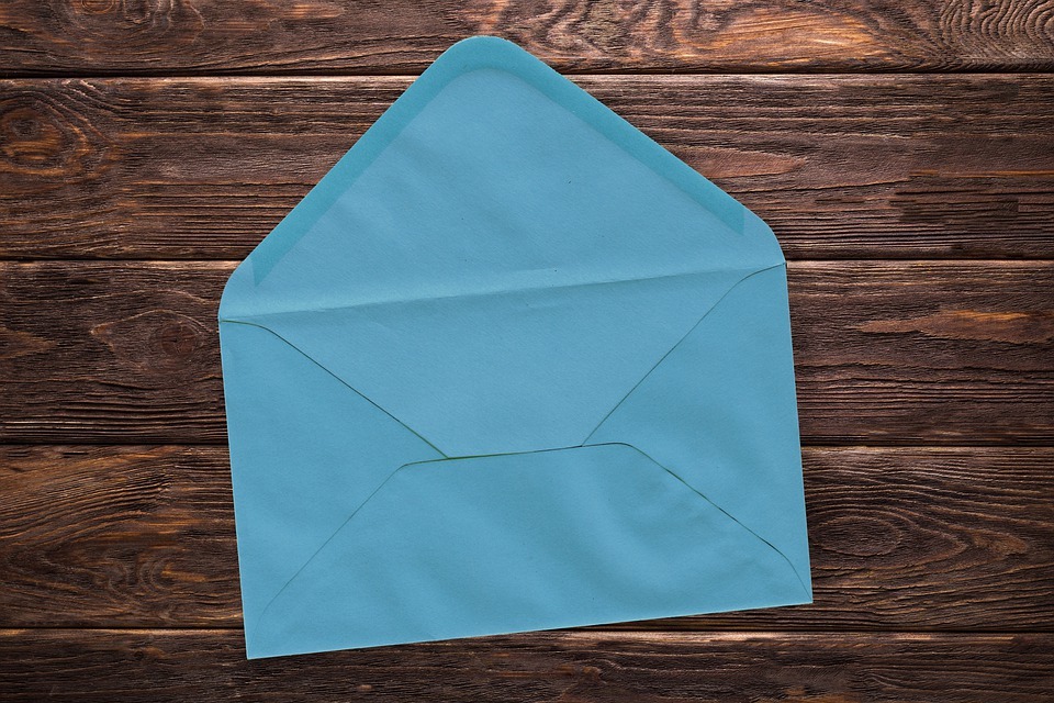 Blue envelope on wooden table
