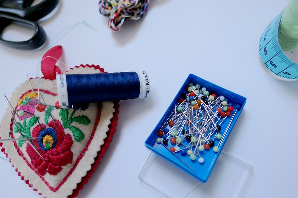 Sewing pouch, thread, and pins