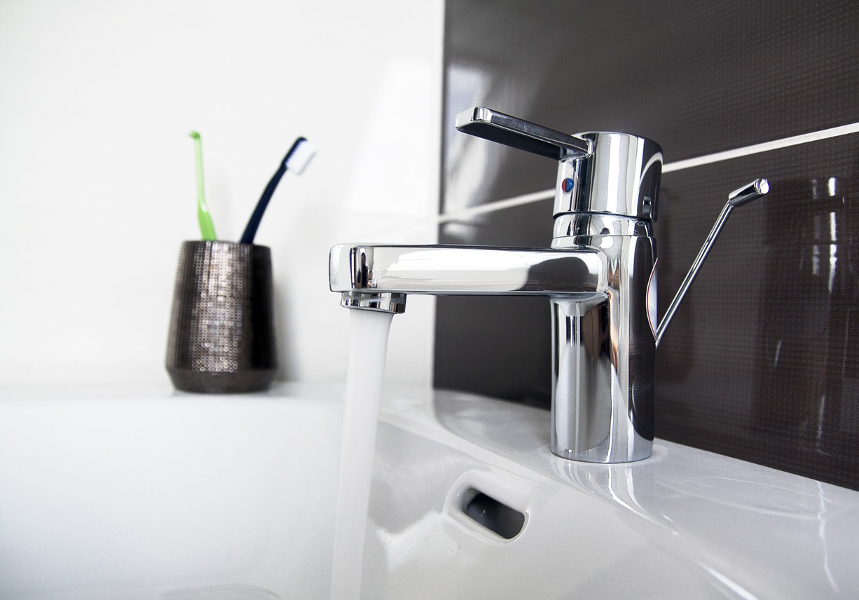 A contemporary bathroom sink with flowing faucet