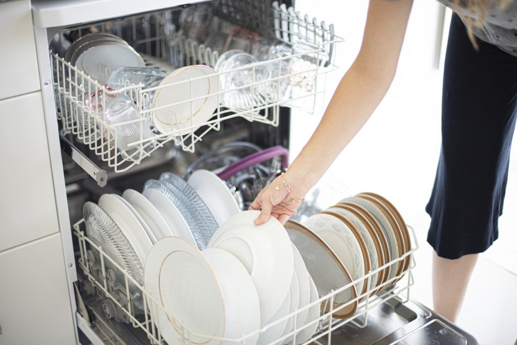 Woman using the dishwasher
