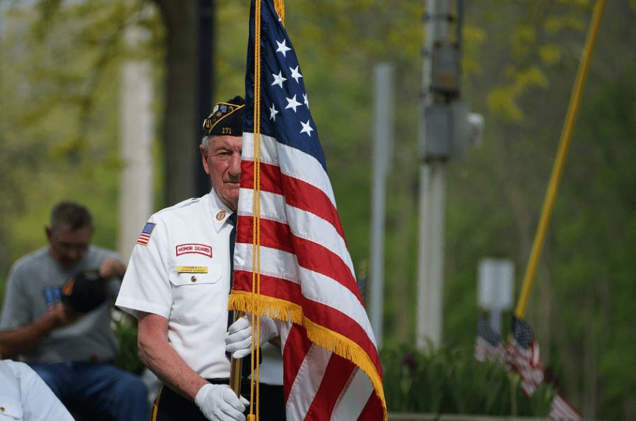 A Veteran holding a US flag