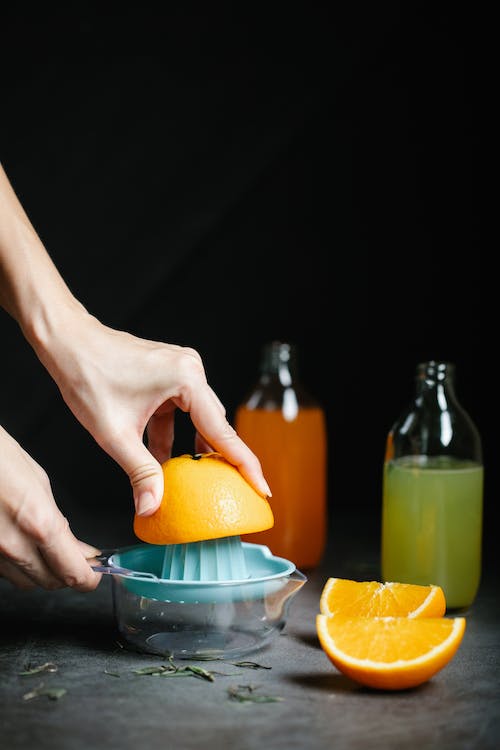 A person preparing juice on a table