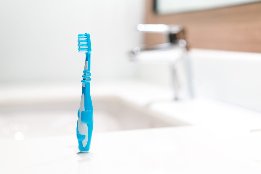 An image of a kid’s toothbrush in the bathroom