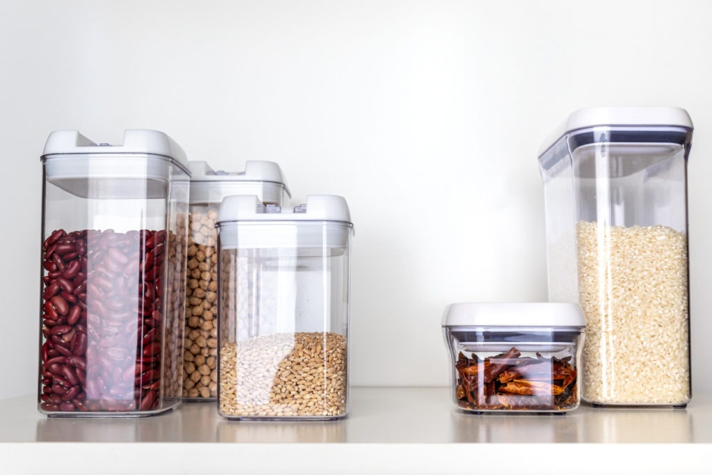 Clear Pantry Containers Filled with Non-Perishable Foods, including Dried Beans and Grains