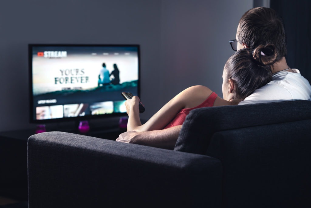 Couple watching a movie on a television