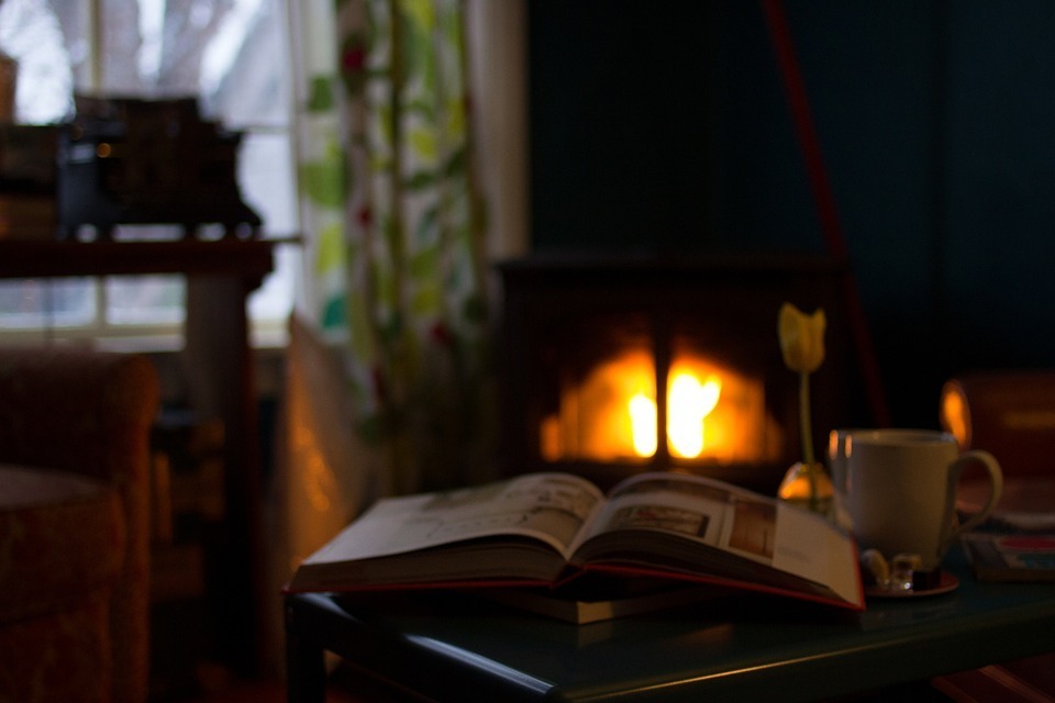 Image-of-a-reading-book-shot-near-a-fireplace.