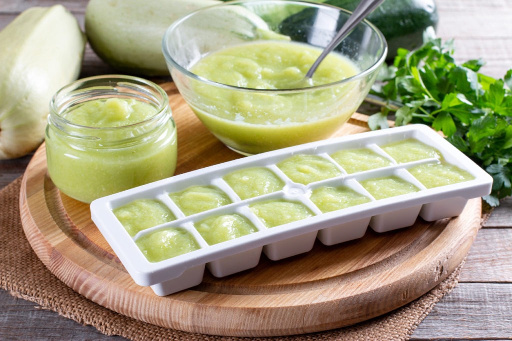 Pureed zucchini in ice cube trays ready for freezing