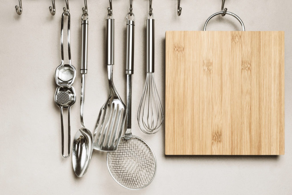 Set of kitchen utensils hanging on a wall