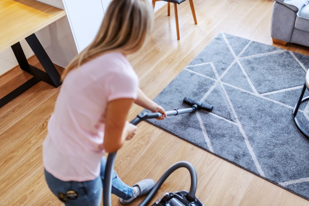 Woman-vacuuming-a-rug
