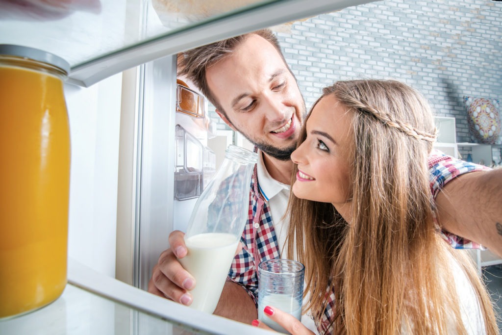 Young couple looking at a refrigerator