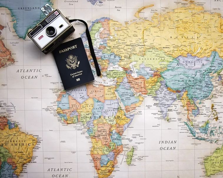 a-camera-and-an-American-passport-on-the-world-map