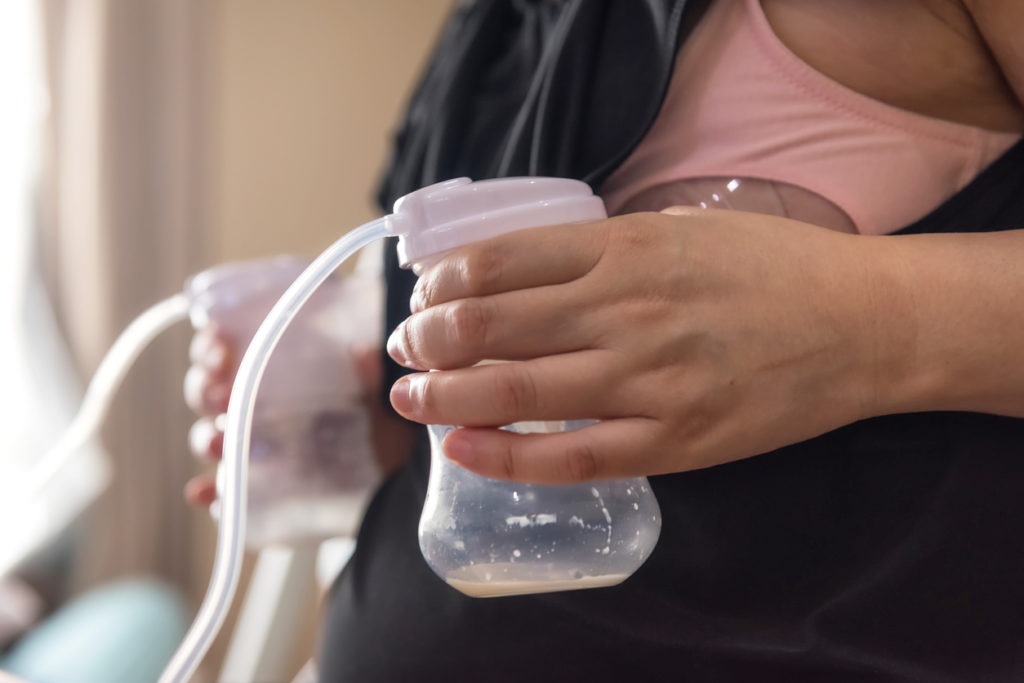 a woman using an automatic breast pump
