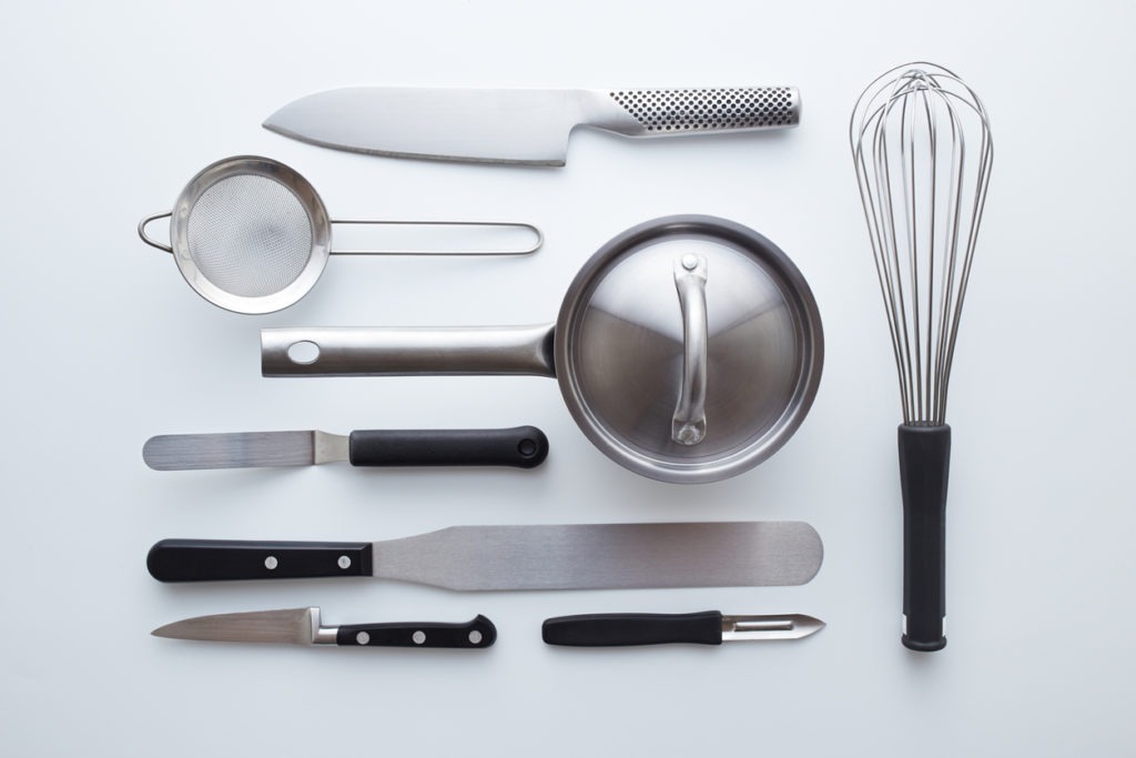 Professional kitchen utensils on white background