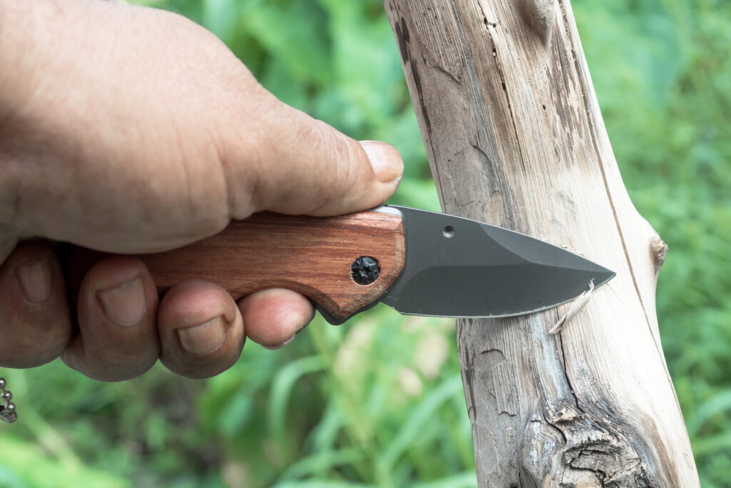 scraping wood using a pocket knife