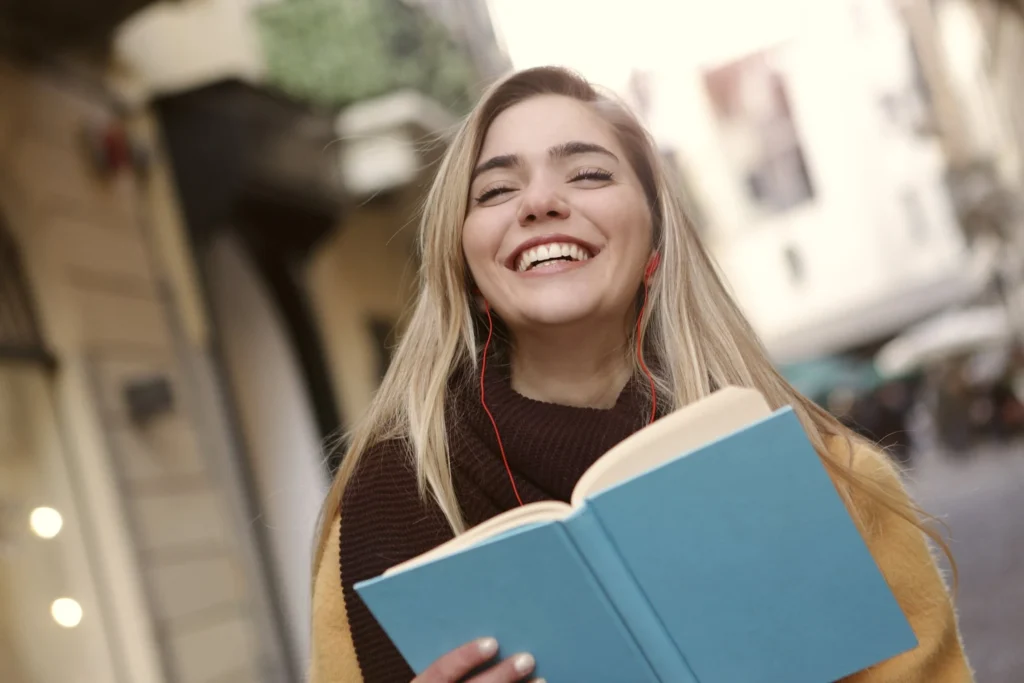 smiling woman while reading a book