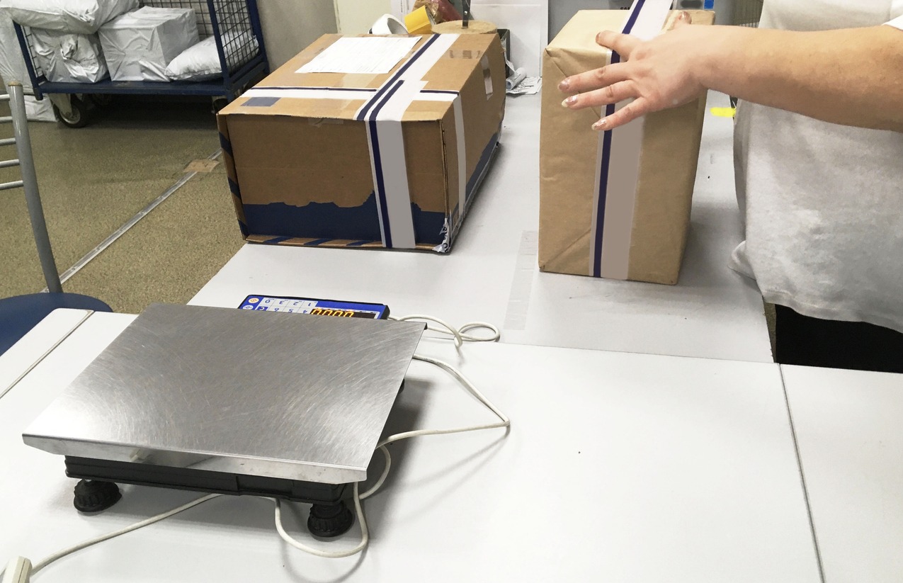 Weighing and packing parcel in the post office