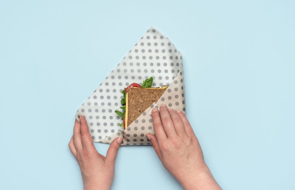 woman wrapping sandwich in a beeswax cloth