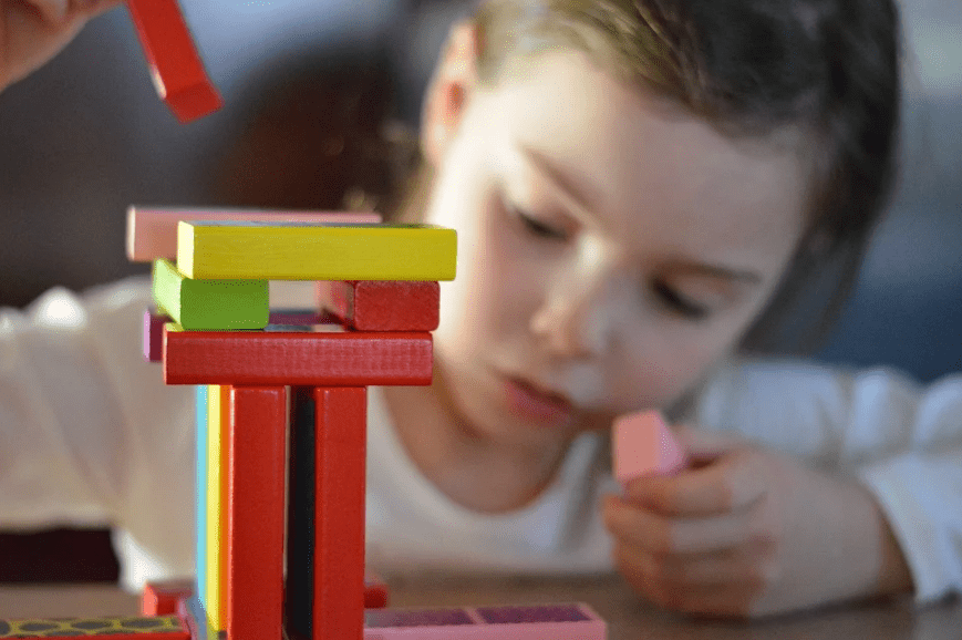 young-child-building-blocks-different-colored-blocks-